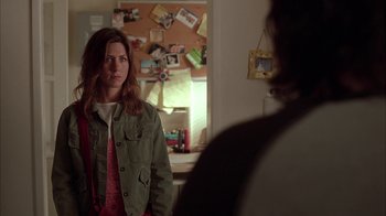 Movie still from “Friends with Money” (2006), directed by Nicole Holofcener – A woman standing in front of a mirror in a room; Medium shot, Over the shoulder angle