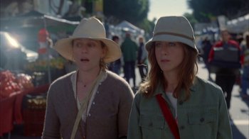 Movie still from “Friends with Money” (2006), directed by Nicole Holofcener – Two women wearing hats are walking down the street; Close Up shot, High angle