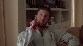 Movie still from “Friends with Money” (2006), directed by Nicole Holofcener – A man holding a nintendo wii game controller in his hand; Close Up shot, Over the shoulder angle