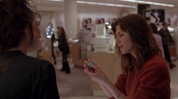 Movie still from “Friends with Money” (2006), directed by Nicole Holofcener – A woman is holding something in her hand while a man looks on; Medium shot, Over the shoulder angle