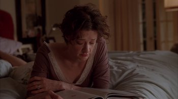 Movie still from “Friends with Money” (2006), directed by Nicole Holofcener – A woman is reading a book on the bed; Close Up shot, High angle
