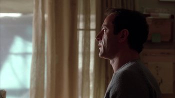 Movie still from “Friends with Money” (2006), directed by Nicole Holofcener – A person in a room with curtains; Close Up shot, Low angle