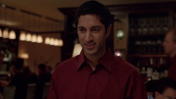 Movie still from “Friends with Money” (2006), directed by Nicole Holofcener – A man in a red shirt is smiling for the camera; Close Up shot, Over the shoulder angle