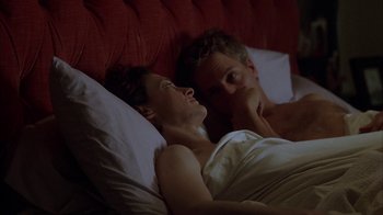 Movie still from “Friends with Money” (2006), directed by Nicole Holofcener – A man and a woman laying in a bed together; Medium shot, Overhead angle