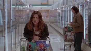 Movie still from “Friends with Money” (2006), directed by Nicole Holofcener – A woman pushing a shopping cart in a grocery store; Medium shot, High angle