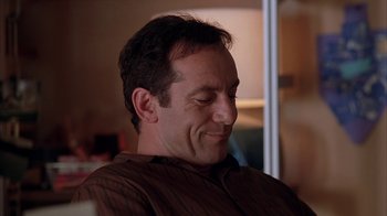 Movie still from “Friends with Money” (2006), directed by Nicole Holofcener – A person sitting in a room; Close Up shot, Low angle