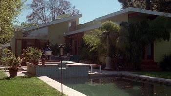 Movie still from “Friends with Money” (2006), directed by Nicole Holofcener – A large pool in front of a house with palm trees in the background; Extreme Wide shot, High angle