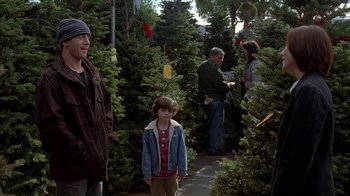 Movie still from “Friends with Money” (2006), directed by Nicole Holofcener – A group of people standing next to trees; Medium shot, Over the shoulder angle