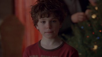 Movie still from “Friends with Money” (2006), directed by Nicole Holofcener – A young boy with curly brown hair wearing a red shirt; Close Up shot, Over the shoulder angle