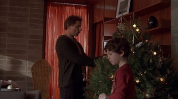 Movie still from “Friends with Money” (2006), directed by Nicole Holofcener – A man and a boy decorating a christmas tree; Medium shot, Over the shoulder angle