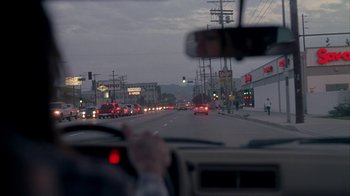 Movie still from “Friends with Money” (2006), directed by Nicole Holofcener – A view from inside a car of a busy street at night; Extreme Wide shot, Over the shoulder angle