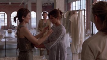 Movie still from “Friends with Money” (2006), directed by Nicole Holofcener – Two women are standing in a dress shop; Medium shot, Over the shoulder angle