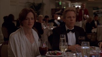 Movie still from “Friends with Money” (2006), directed by Nicole Holofcener – A man and a woman sitting at a dinner table; Medium shot, Over the shoulder angle
