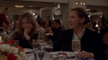Movie still from “Friends with Money” (2006), directed by Nicole Holofcener – A man and a woman sitting at a dinner table; Medium shot, Over the shoulder angle