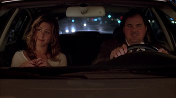 Movie still from “Friends with Money” (2006), directed by Nicole Holofcener – A man and a woman sitting in the back seat of a car; Medium shot, Over the shoulder angle