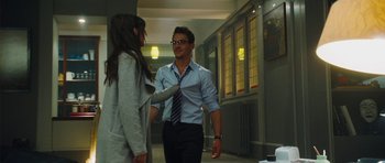 Movie still from “From Paris with Love” (2010), directed by Pierre Morel – A man and a woman are talking in a hallway; Medium shot, Over the shoulder angle