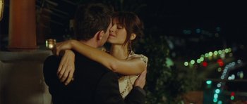 Movie still from “From Paris with Love” (2010), directed by Pierre Morel – A man and a woman kissing each other; Close Up shot, Over the shoulder angle