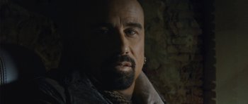 Movie still from “From Paris with Love” (2010), directed by Pierre Morel – A person with a beard; Close Up shot, Over the shoulder angle