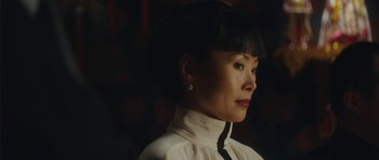 Movie still from “From Paris with Love” (2010), directed by Pierre Morel – A person wearing a shirt and tie; Close Up shot, Over the shoulder angle