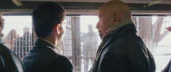 Movie still from “From Paris with Love” (2010), directed by Pierre Morel – Two men looking out of a window at each other; Close Up shot, Over the shoulder angle