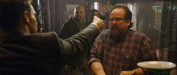 Movie still from “From Paris with Love” (2010), directed by Pierre Morel – A man holding a gun up to his head; Medium shot, Over the shoulder angle