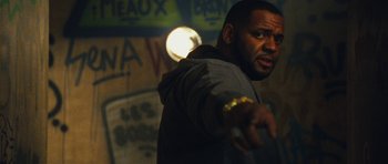 Movie still from “From Paris with Love” (2010), directed by Pierre Morel – A man with a beard is pointing his finger at the camera; Close Up shot, Low angle