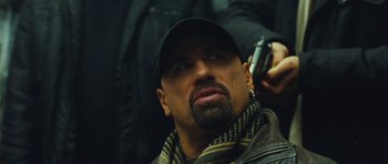 Movie still from “From Paris with Love” (2010), directed by Pierre Morel – A person with a cell phone; Close Up shot, Over the shoulder angle