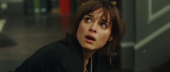 Movie still from “From Paris with Love” (2010), directed by Pierre Morel – A person looking up at something; Close Up shot, High angle