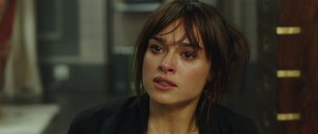 Movie still from “From Paris with Love” (2010), directed by Pierre Morel – A person wearing a jacket; Close Up shot, Over the shoulder angle