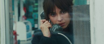 Movie still from “From Paris with Love” (2010), directed by Pierre Morel – A woman holding a phone up to her ear; Close Up shot, High angle