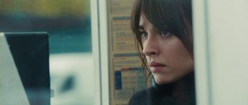Movie still from “From Paris with Love” (2010), directed by Pierre Morel – A person with long brown hair; Close Up shot, Over the shoulder angle