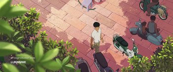 Movie still from “Funan” (2018), directed by Denis Do – A man walking down the street with a camera in his hand; Wide shot, High angle