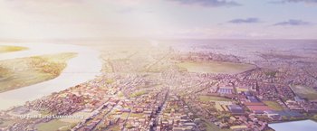 Movie still from “Funan” (2018), directed by Denis Do – An aerial view of a large city with lots of buildings; Extreme Wide shot, High angle