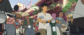 Movie still from “Funan” (2018), directed by Denis Do – A man on a moped in a crowded street; Medium shot, High angle