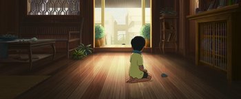 Movie still from “Funan” (2018), directed by Denis Do – A little boy sitting on the floor in front of a window; Wide shot, High angle