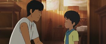 Movie still from “Funan” (2018), directed by Denis Do – A man standing next to a young boy in a room; Close Up shot, Over the shoulder angle
