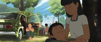 Movie still from “Funan” (2018), directed by Denis Do – An animated scene of a man and a woman in a park; Medium shot, Low angle