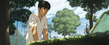 Movie still from “Funan” (2018), directed by Denis Do – An animated picture of a man standing in the grass; Medium shot, Low angle