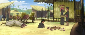 Movie still from “Funan” (2018), directed by Denis Do – An illustration of a person sitting in the dirt; Wide shot, High angle