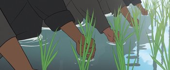Movie still from “Funan” (2018), directed by Denis Do – Two people holding hands in the grass; Extreme Close Up shot, Overhead angle