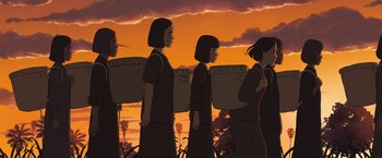 Movie still from “Funan” (2018), directed by Denis Do – A group of people standing next to each other on a field; Wide shot, Low angle