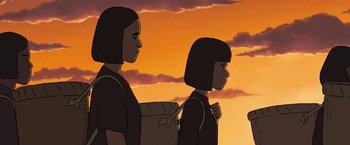 Movie still from “Funan” (2018), directed by Denis Do – A couple of people standing next to each other on top of a hill; Medium shot, Over the shoulder angle