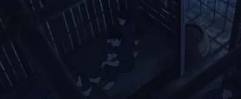 Movie still from “Funan” (2018), directed by Denis Do – A couple of people sitting next to each other on a porch; Wide shot, Overhead angle