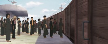 Movie still from “Funan” (2018), directed by Denis Do – A group of people standing next to a fence; Wide shot, Low angle