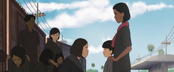 Movie still from “Funan” (2018), directed by Denis Do – An illustration of a group of people standing together; Medium shot, Over the shoulder angle
