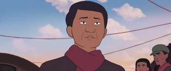 Movie still from “Funan” (2018), directed by Denis Do – An animated picture of a man in a scarf; Close Up shot, Low angle