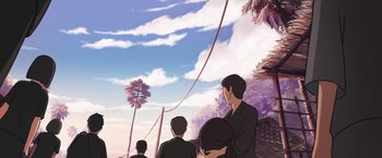 Movie still from “Funan” (2018), directed by Denis Do – A group of people standing next to each other on top of a hill; Wide shot, Low angle