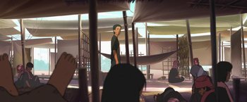 Movie still from “Funan” (2018), directed by Denis Do – A man standing in front of a group of people in a room; Wide shot, Over the shoulder angle