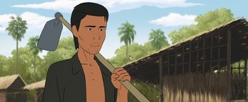 Movie still from “Funan” (2018), directed by Denis Do – An animated man holding a wooden stick in his hand; Close Up shot, Over the shoulder angle