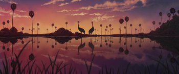 Movie still from “Funan” (2018), directed by Denis Do – Two birds are standing in front of a body of water at sunset; Extreme Wide shot, Low angle